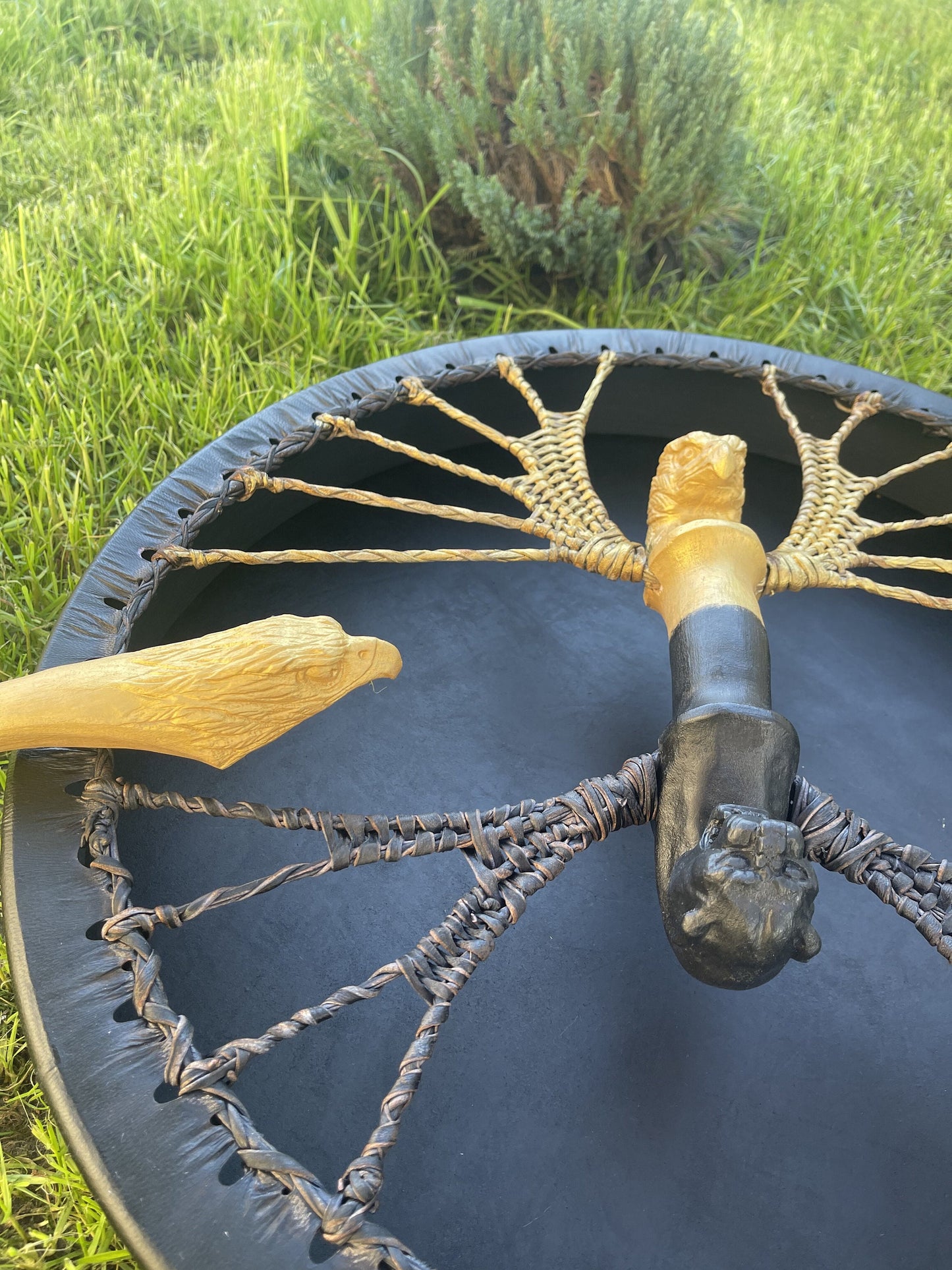 Black frame drum with two carved handles, jaguar and eagle